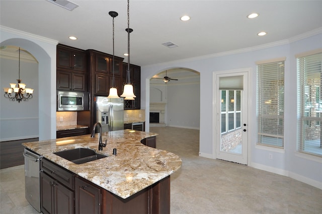 15818 Tremout Hollow Ln, Houston, TX 77044 - kitchen with arched walkways, stainless steel appliances, a sink, tasteful backsplash, and crown molding