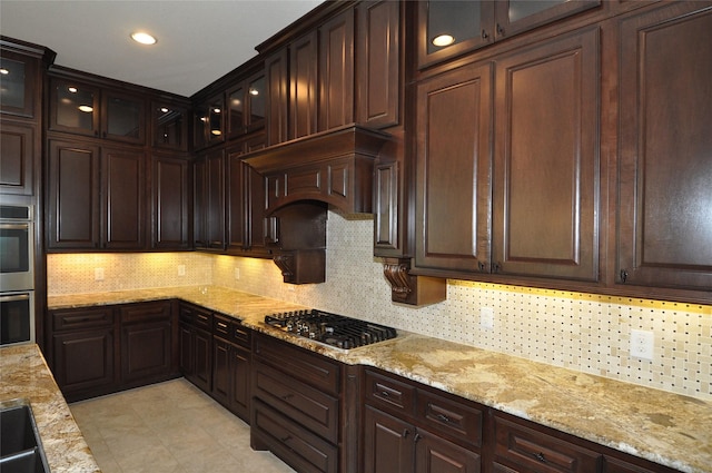 15818 Tremout Hollow Ln, Houston, TX 77044 - kitchen with appliances with stainless steel finishes, backsplash, dark brown cabinetry, light stone counters, and recessed lighting