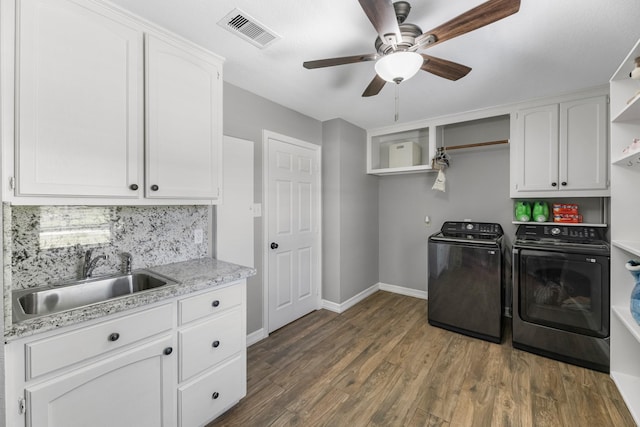 16610 Meadow Ln Unit Cr438, Danbury, TX 77534 - washroom with separate washer and dryer, cabinet space, baseboards, ceiling fan, and dark wood-type flooring