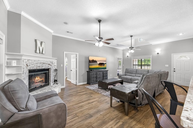 16610 Meadow Ln Unit Cr438, Danbury, TX 77534 - living room featuring ornamental molding, wood finished floors, ceiling fan, a textured ceiling, and a premium fireplace