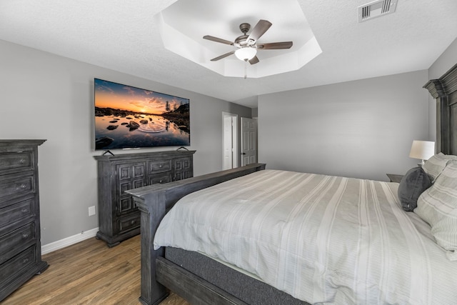16610 Meadow Ln Unit Cr438, Danbury, TX 77534 - bedroom with wood finished floors, baseboards, a tray ceiling, ceiling fan, and a skylight