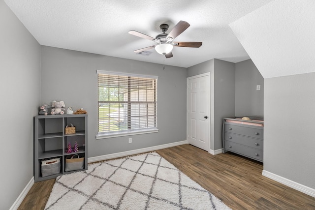 16610 Meadow Ln Unit Cr438, Danbury, TX 77534 - bedroom with wood finished floors, a textured ceiling, baseboards, and ceiling fan