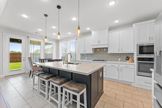 2006 Green Haven Ct, Missouri City, TX 77459 - kitchen with a sink, stainless steel appliances, light countertops, recessed lighting, and decorative backsplash