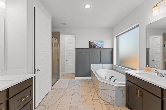 2006 Green Haven Ct, Missouri City, TX 77459 - full bathroom featuring marble look tiles, a shower stall, a bath, two vanities, and recessed lighting