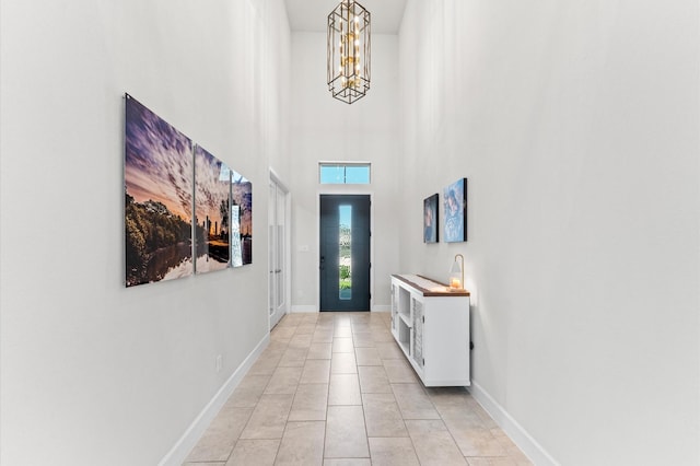 2006 Green Haven Ct, Missouri City, TX 77459 - entryway featuring a chandelier, a high ceiling, baseboards, and light tile patterned floors