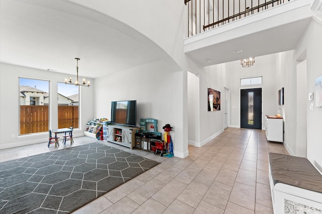 2006 Green Haven Ct, Missouri City, TX 77459 - entryway featuring a chandelier, arched walkways, tile patterned flooring, a towering ceiling, and baseboards