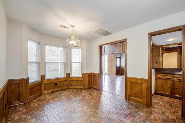 506 Windsor Glen Dr, Katy, TX 77450 - unfurnished dining area with wainscoting, a chandelier, and wooden walls
