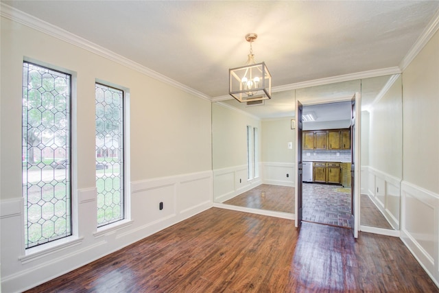 506 Windsor Glen Dr, Katy, TX 77450 - unfurnished dining area with wood finished floors, a chandelier, a decorative wall, crown molding, and a wainscoted wall