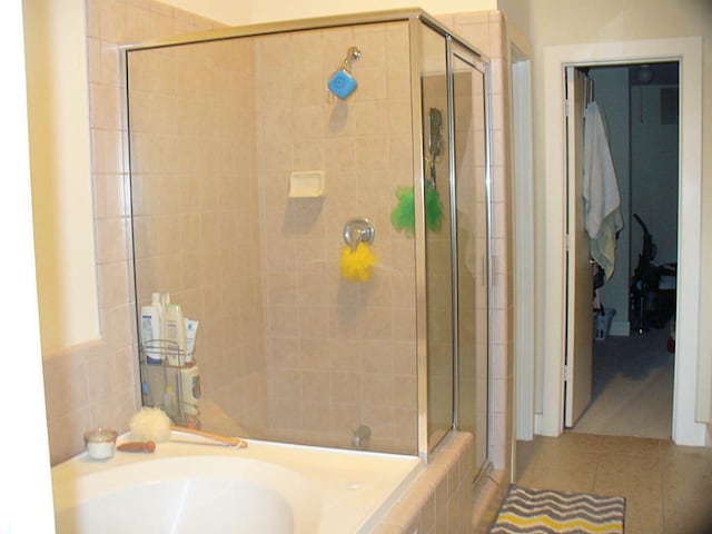3501 Link Valley Dr Unit 1004, Houston, TX 77025 - full bath with a stall shower, a bath, and tile patterned flooring
