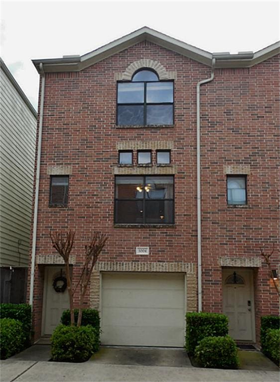 3501 Link Valley Dr Unit 1004, Houston, TX 77025 - view of building exterior with concrete driveway and an attached garage
