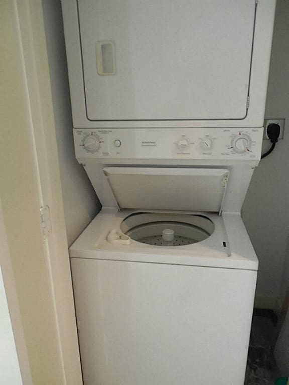3501 Link Valley Dr Unit 1004, Houston, TX 77025 - washroom featuring stacked washing machine and dryer