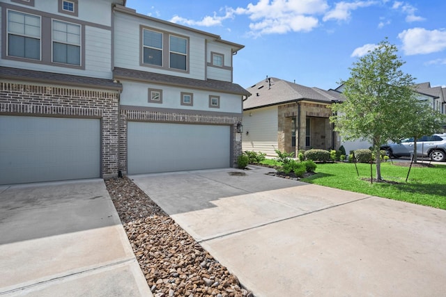 255 S Spotted Fern Dr, Montgomery, TX 77316 - townhome / multi-family property with an attached garage, concrete driveway, a front lawn, brick siding, and stucco siding