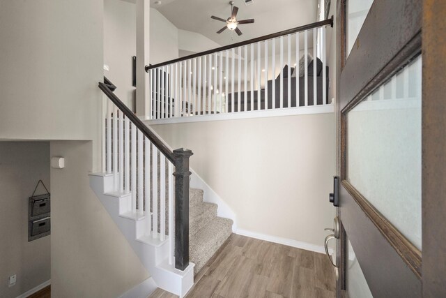 255 S Spotted Fern Dr, Montgomery, TX 77316 - stairs featuring wood finished floors, a ceiling fan, baseboards, and vaulted ceiling