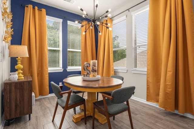 255 S Spotted Fern Dr, Montgomery, TX 77316 - dining room featuring a chandelier, wood finished floors, and baseboards