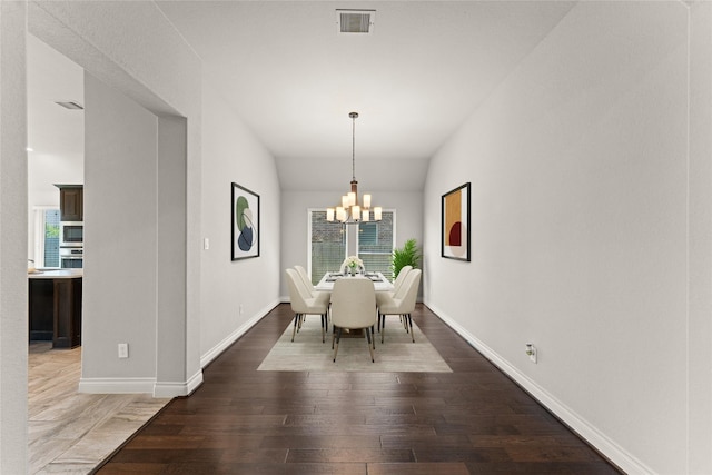 3319 Sky Run Ct, Missouri City, TX 77459 - dining room featuring wood finished floors, healthy amount of natural light, a chandelier, baseboards, and lofted ceiling