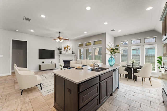 3319 Sky Run Ct, Missouri City, TX 77459 - kitchen featuring a sink, dishwasher, light countertops, a fireplace, and ceiling fan