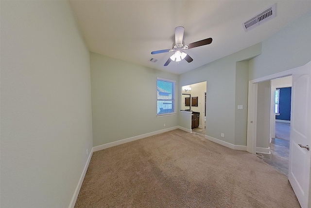2308 Ellis Park Ln, Conroe, TX 77304 - unfurnished bedroom featuring multiple windows, light carpet, and baseboards