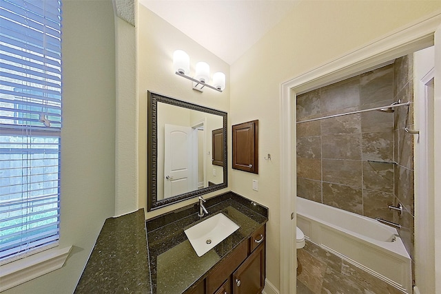 2308 Ellis Park Ln, Conroe, TX 77304 - bathroom featuring toilet, vanity, tub / shower combination, and vaulted ceiling