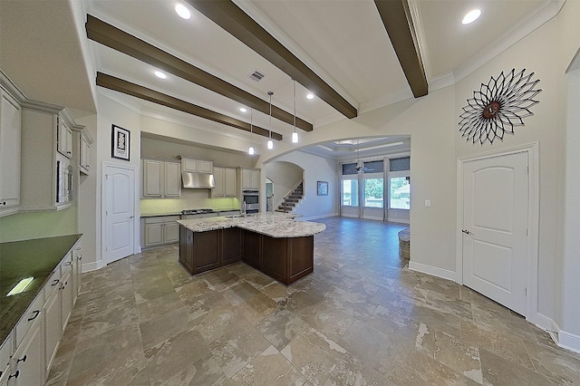2308 Ellis Park Ln, Conroe, TX 77304 - kitchen with arched walkways, beamed ceiling, stone tile flooring, open floor plan, and a kitchen island