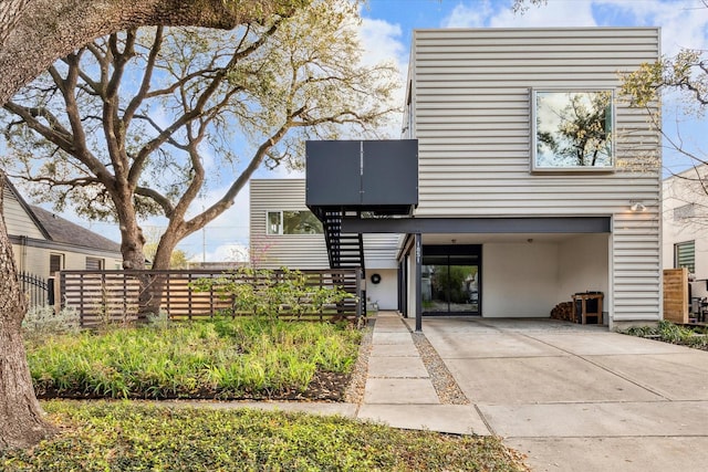 1851 Lexington St, Houston, TX 77098 - modern home featuring stucco siding, fence, driveway, stairway, and a carport