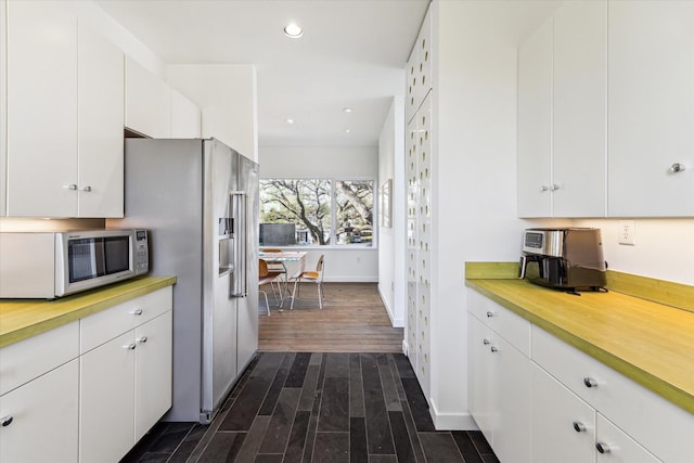 1851 Lexington St, Houston, TX 77098 - kitchen featuring white microwave, light countertops, high quality fridge, dark wood-style flooring, and white cabinets