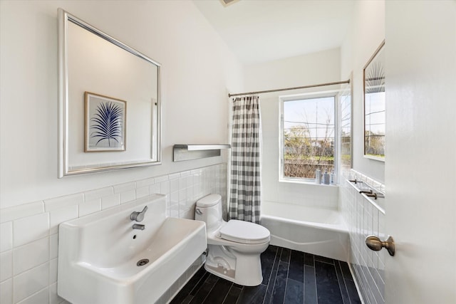 1851 Lexington St, Houston, TX 77098 - full bath featuring tile walls, toilet, wood finished floors, wainscoting, and shower / tub combo