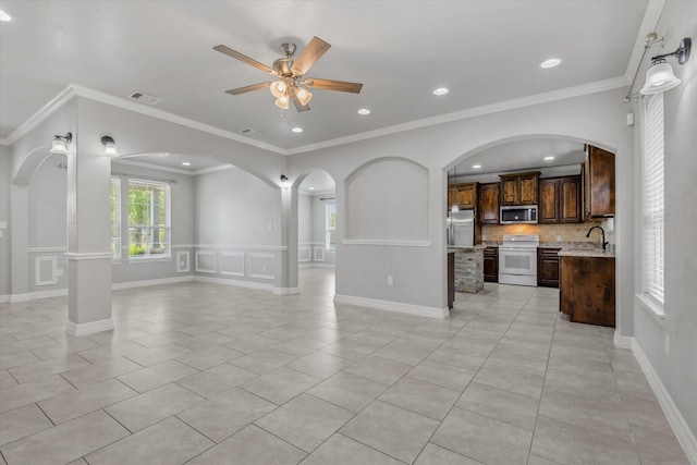 2800 Virginia Ave, League City, TX 77573 - unfurnished living room with a ceiling fan, light tile patterned flooring, a sink, arched walkways, and ornamental molding