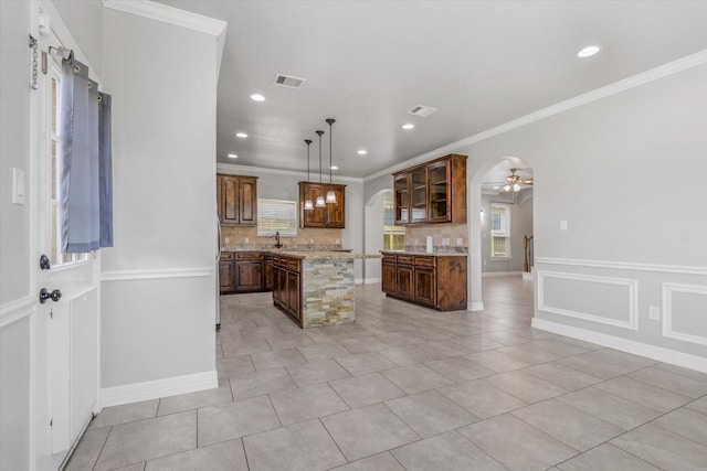 2800 Virginia Ave, League City, TX 77573 - kitchen featuring decorative backsplash, a center island, arched walkways, ceiling fan, and glass insert cabinets
