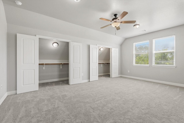 2800 Virginia Ave, League City, TX 77573 - unfurnished bedroom with two closets, carpet, baseboards, lofted ceiling, and a ceiling fan