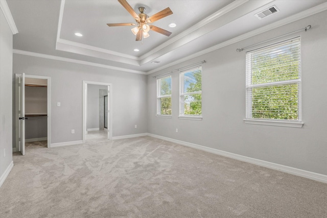 2800 Virginia Ave, League City, TX 77573 - unfurnished bedroom with light carpet, a spacious closet, baseboards, crown molding, and a tray ceiling