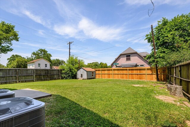 2800 Virginia Ave, League City, TX 77573 - view of yard featuring central AC unit, a shed, and an outbuilding