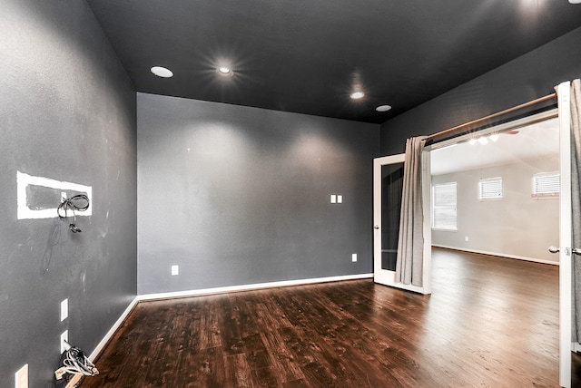 empty room featuring wood finished floors and baseboards