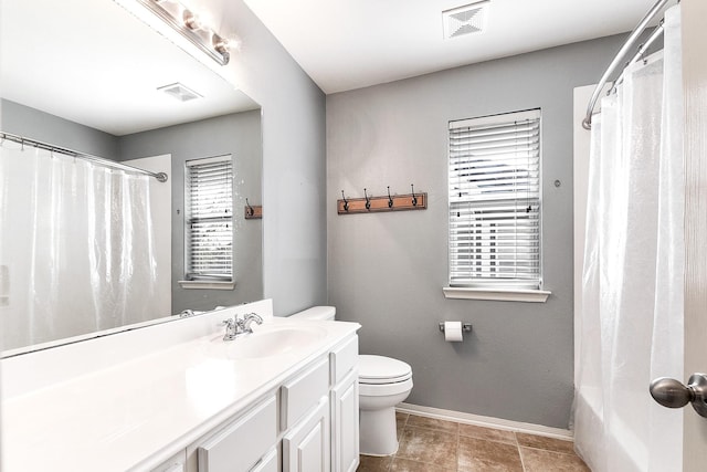 full bathroom featuring baseboards, toilet, vanity, and tile patterned floors