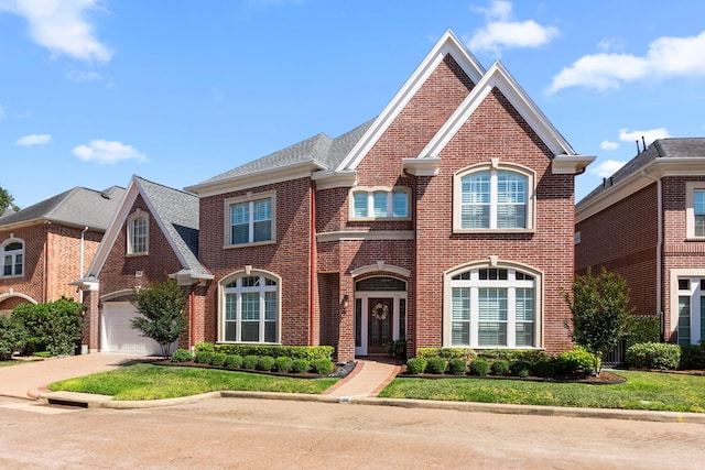 38 Ambleside Crescent Dr, Sugar Land, TX 77479 - colonial-style house featuring brick siding, concrete driveway, and a garage