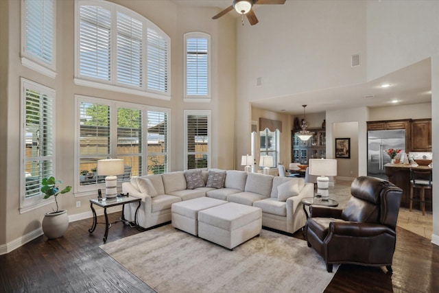 401 Bastrop Dr, Allen, TX 75013 - living area with ceiling fan, a towering ceiling, baseboards, and wood finished floors