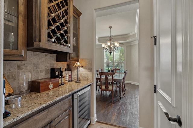 401 Bastrop Dr, Allen, TX 75013 - kitchen featuring wine cooler, crown molding, a chandelier, decorative backsplash, and glass insert cabinets