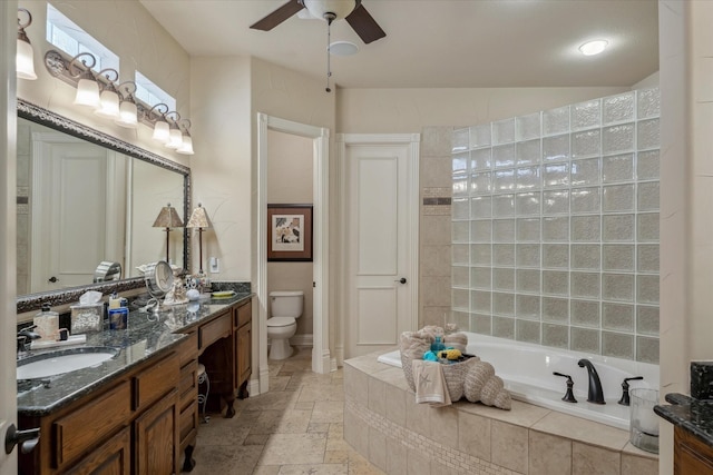 401 Bastrop Dr, Allen, TX 75013 - full bathroom with ceiling fan, a garden tub, stone tile floors, double vanity, and toilet