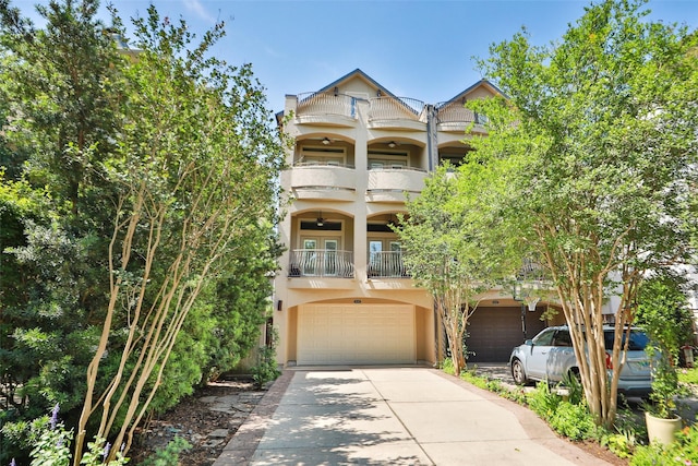 6635 Wanita Pl Unit B, Houston, TX 77007 - view of front of house with a balcony, stucco siding, a garage, and concrete driveway
