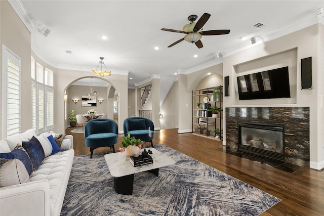 6635 Wanita Pl Unit B, Houston, TX 77007 - living area with arched walkways, a fireplace with flush hearth, wood finished floors, recessed lighting, and crown molding