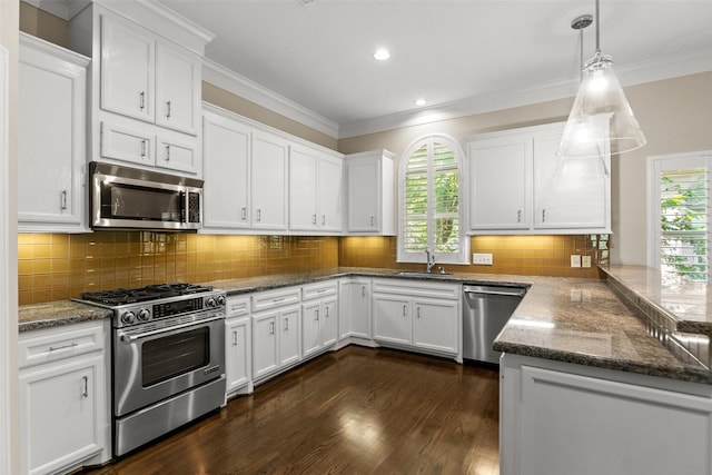 6635 Wanita Pl Unit B, Houston, TX 77007 - kitchen with stainless steel appliances, ornamental molding, white cabinets, dark stone countertops, and dark wood-type flooring