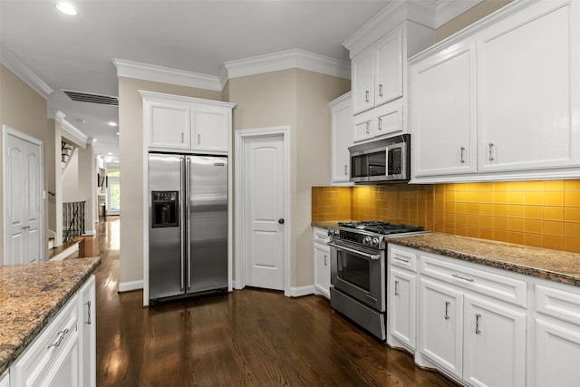 6635 Wanita Pl Unit B, Houston, TX 77007 - kitchen featuring stainless steel appliances, dark wood-type flooring, dark stone counters, white cabinetry, and backsplash