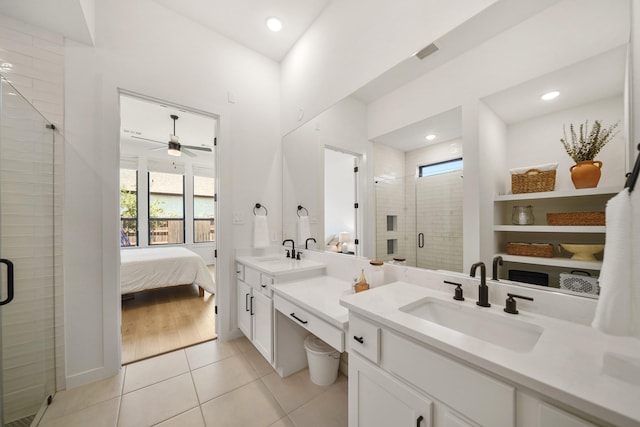 30246 Gold Finch Pl, Fulshear, TX 77441 - bathroom featuring tile patterned floors, a shower stall, ceiling fan, two vanities, and connected bathroom