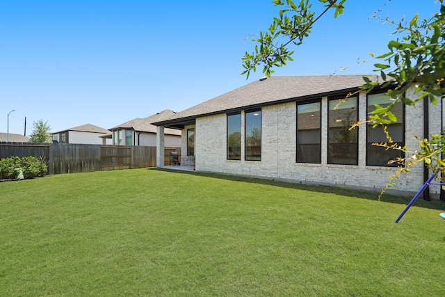 30246 Gold Finch Pl, Fulshear, TX 77441 - back of property featuring roof with shingles and brick siding