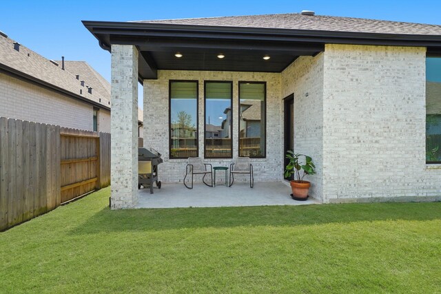 30246 Gold Finch Pl, Fulshear, TX 77441 - rear view of property featuring a patio area and brick siding