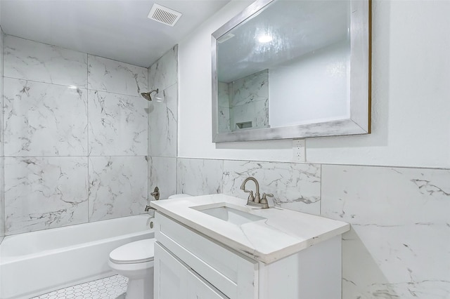 1316 Bailey St, Wharton, TX 77488 - bathroom with tile walls, vanity, toilet, and shower / bathtub combination