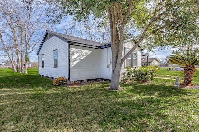 1316 Bailey St, Wharton, TX 77488 - view of home's exterior featuring a yard and a shingled roof