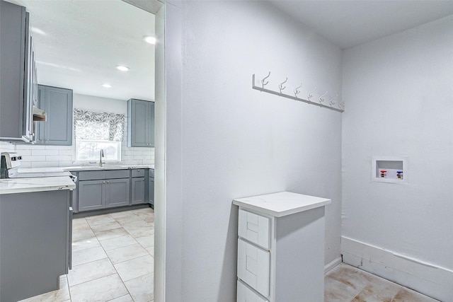 1316 Bailey St, Wharton, TX 77488 - clothes washing area featuring washer hookup, recessed lighting, and light tile patterned floors
