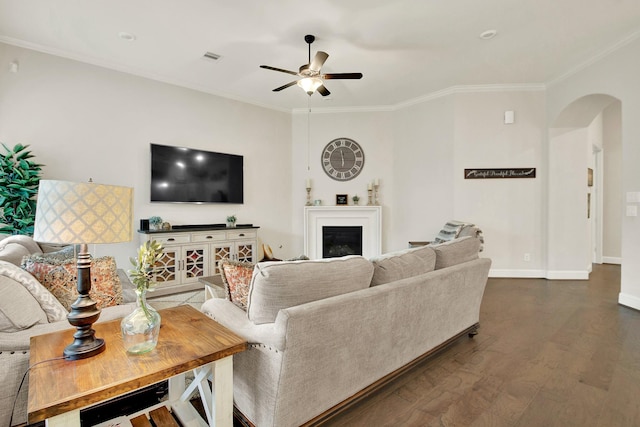 510 Blossom Cove Ct, Pinehurst, TX 77362 - living area featuring arched walkways, a ceiling fan, crown molding, dark wood-style flooring, and a fireplace