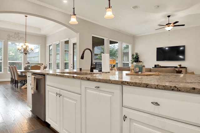 510 Blossom Cove Ct, Pinehurst, TX 77362 - kitchen featuring a sink, stainless steel dishwasher, dark wood-style flooring, arched walkways, and light stone countertops