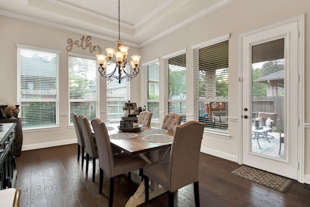 510 Blossom Cove Ct, Pinehurst, TX 77362 - dining space with a tray ceiling, healthy amount of natural light, dark wood-style floors, and ornamental molding